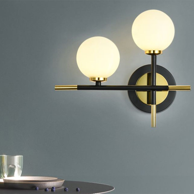 Modern Milk Glass Orb Sconce Wall Light - 2 Lights Black And Brass Cross Design