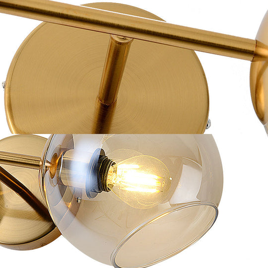 Modernist Gold Wall Lamp With Clear Glass Shade - 2 Lights Spherical Mount Fixture