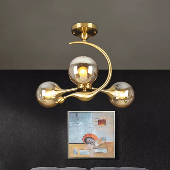 Burst Amber Glass Orb Semi Flush Chandelier - Postmodern 3/5 Heads Brass Ceiling Mounted Light with Curved Arm