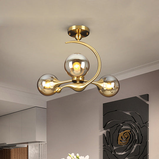 Burst Amber Glass Orb Semi Flush Chandelier - Postmodern 3/5 Heads Brass Ceiling Mounted Light with Curved Arm