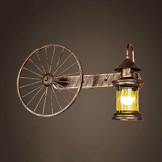 Coastal Brass Amber Glass Wall Sconce With Wagon Wheel Deco