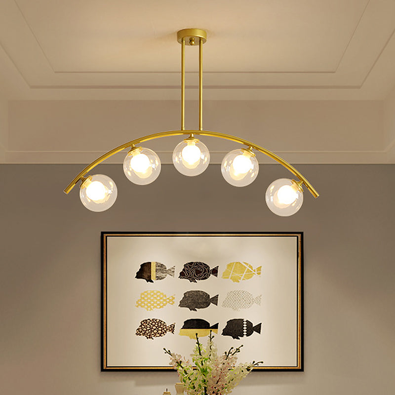 Modern Glass Orb Island Pendant Light With Brass Arch Arm - 5 Bulbs White/Clear Design For Dining