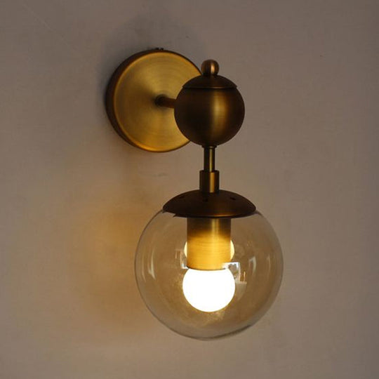 Post Modern Amber Glass Globe Wall Sconce With Brass Mount - 1/2 Light