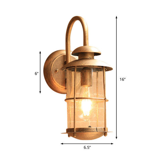 Coastal Clear Glass Wall Sconce With Brass Cage And Cylinder Light