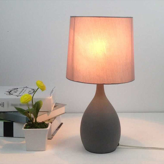 Minimalist Single Grey Metal Night Lamp With Teardrop Shape Cylinder Fabric Shade And Table Stand