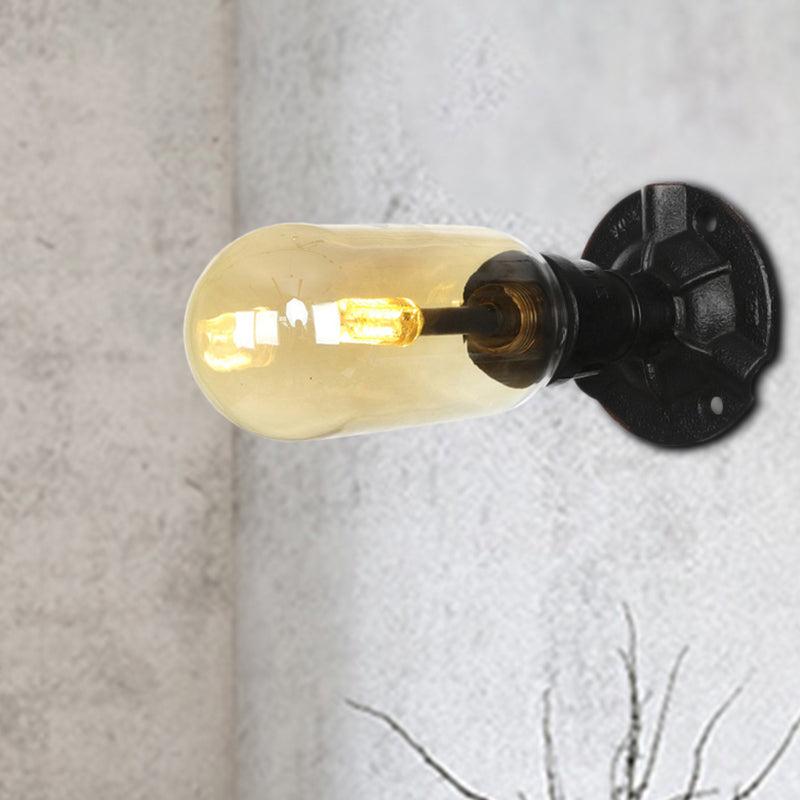 Industrial Dining Room Wall Sconce Lighting Fixture In Black - Amber Glass Capsule With Pipe Design