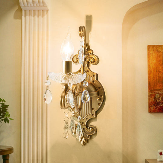 Traditional Crystal Candle Wall Sconce With Antiqued Brass Finish And Scroll Arm