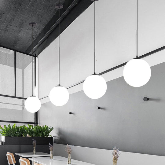 Sleek Black Sphere Restaurant Pendant Light with Cream Glass Shade - Simple Ceiling Hang Lamp