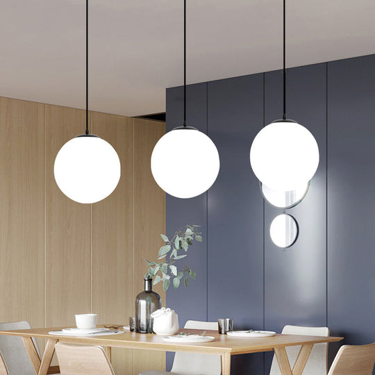 Sleek Black Sphere Restaurant Pendant Light with Cream Glass Shade - Simple Ceiling Hang Lamp