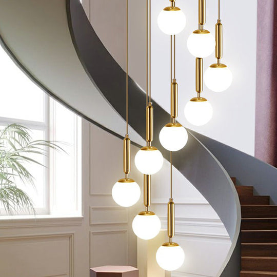 Gold Multi Hanging Stairway Light with Minimalist White Glass Ball Pendant