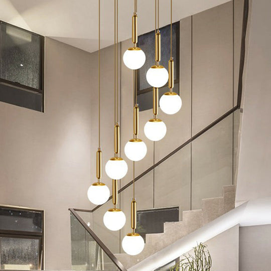 Gold Multi Hanging Stairway Light with Minimalist White Glass Ball Pendant