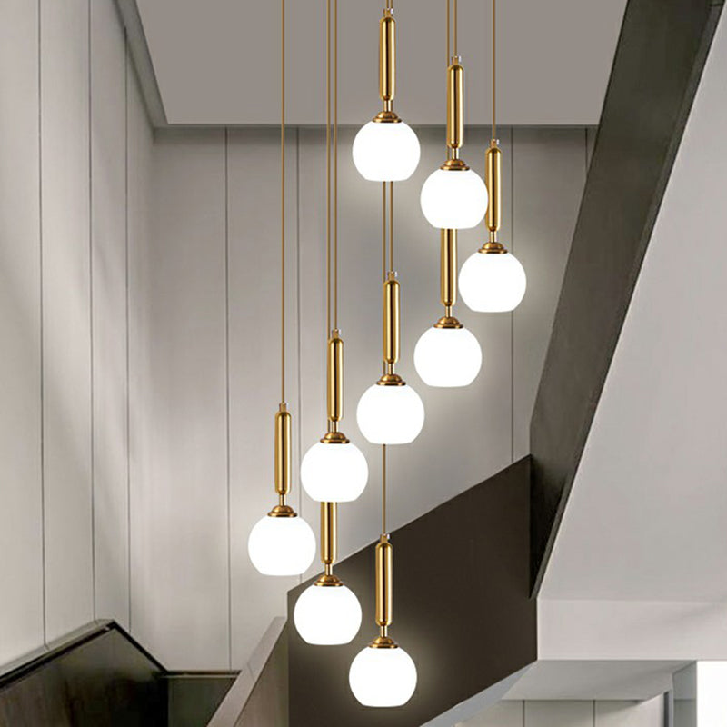 Gold Multi Hanging Stairway Light with Minimalist White Glass Ball Pendant