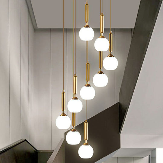 Gold Multi Hanging Stairway Light with Minimalist White Glass Ball Pendant