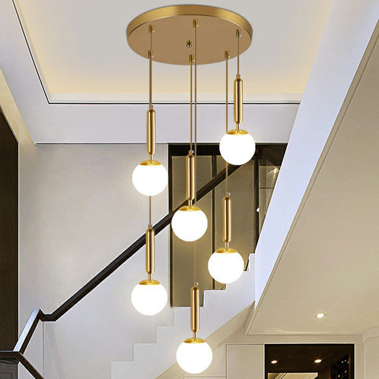 Gold Multi Hanging Stairway Light with Minimalist White Glass Ball Pendant