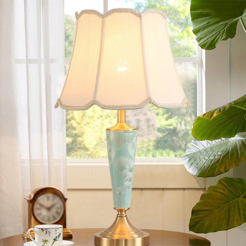 Blue Fabric Table Lamp With Scalloped Shade For A Classic Nighttime Glow