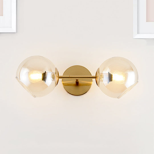 Modernist Gold Wall Lamp With Clear Glass Shade - 2 Lights Spherical Mount Fixture