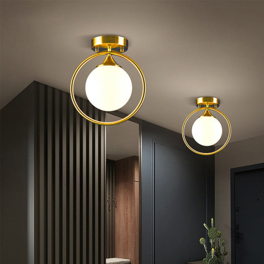 Postmodern Glass Ball Ceiling Light With Brass Metal Ring - 1-Light Semi-Flush Mount For Corridors