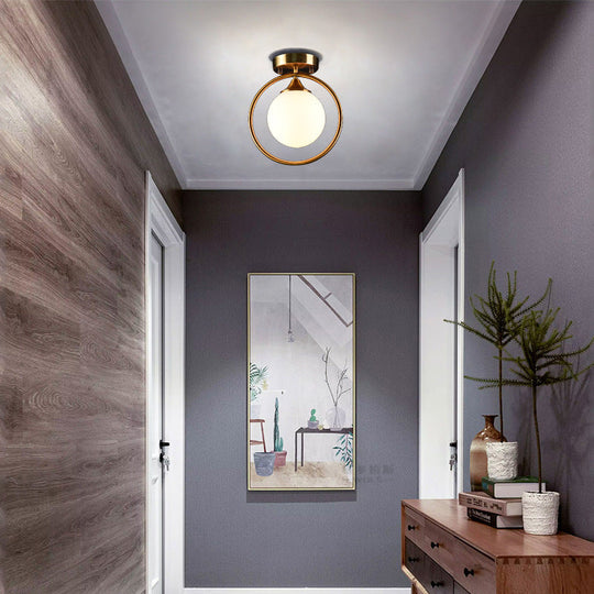 Postmodern Glass Ball Ceiling Light With Brass Metal Ring - 1-Light Semi-Flush Mount For Corridors