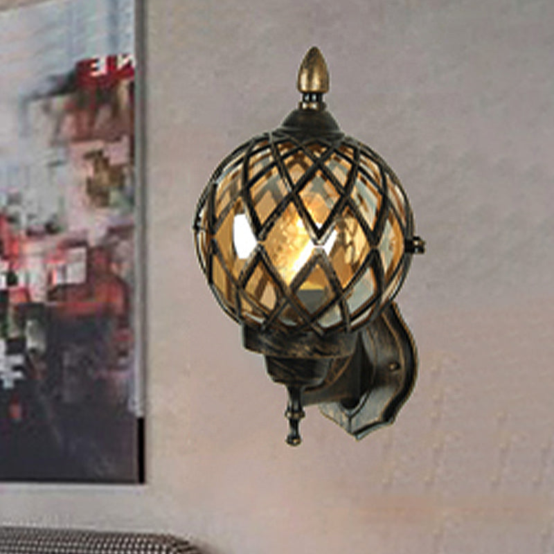 Amber Glass Wall Sconce With Industrial Cage And Black Globe For Dining Room Lighting