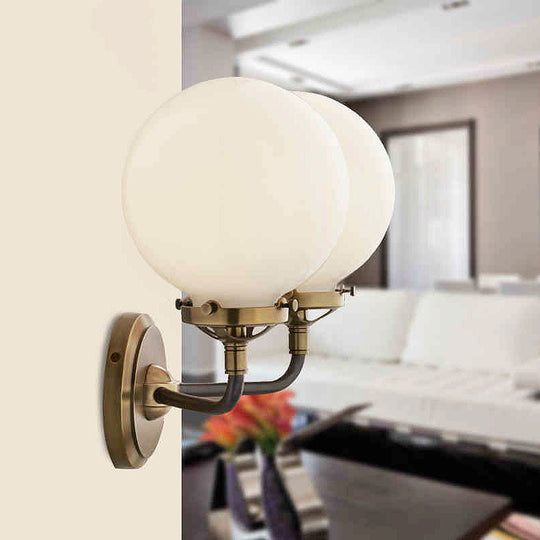 Modern Opal Glass Sconce Light With Globe Shade In Antique Brass/Chrome