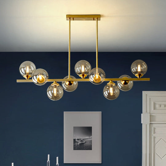 Mid-Century Modern Gold Metal Pendant With Spherical Amber Glass - Island Ceiling Light For Dining