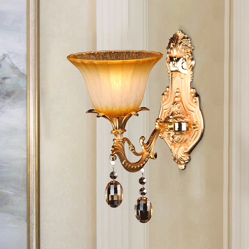 Amber Glass Wall Sconce With Brass Flower Detail For Traditional Bedroom Lighting