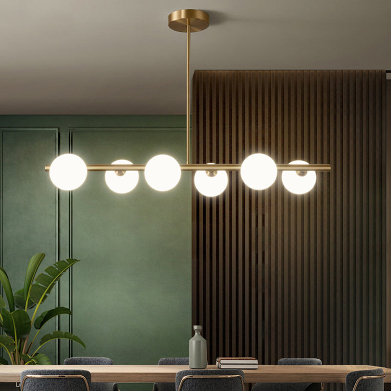 Linear Gold Pendant Light With Spherical Glass For Modern Minimalist Dining Table