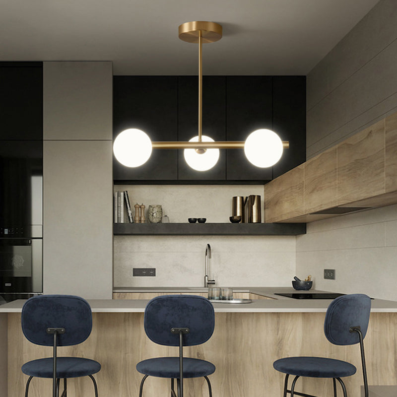 Linear Gold Pendant Light With Spherical Glass For Modern Minimalist Dining Table