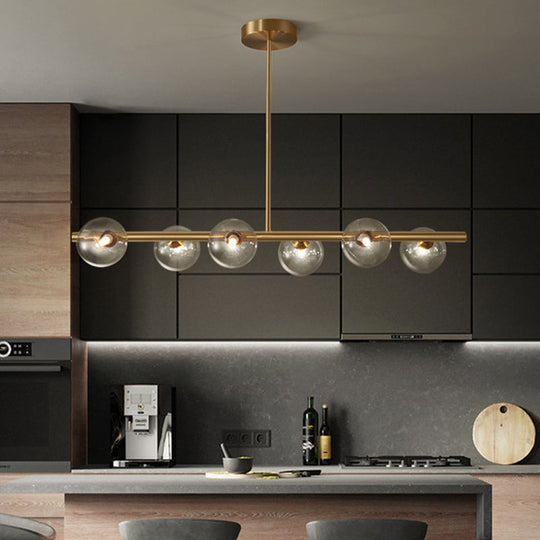 Linear Gold Pendant Light With Spherical Glass For Modern Minimalist Dining Table