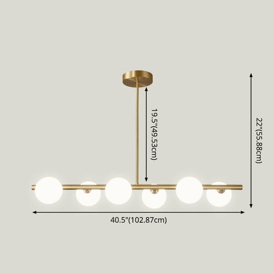 Linear Gold Pendant Light With Spherical Glass For Modern Minimalist Dining Table