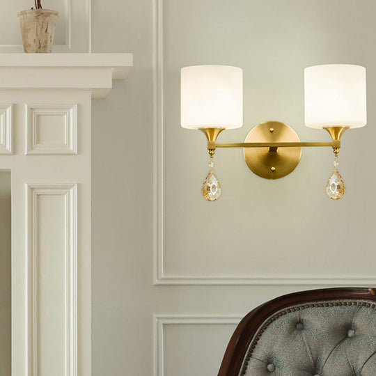 Modern Milk Glass Wall Sconce With Brass Finish And Amber Crystal Draping