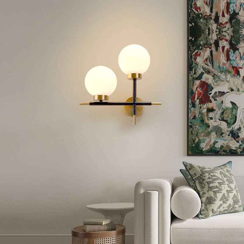 Post-Modern White Glass Sphere Wall Sconce With Brass Finish - 1/2 Bulbs