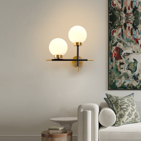 Post-Modern White Glass Sphere Wall Sconce With Brass Finish - 1/2 Bulbs