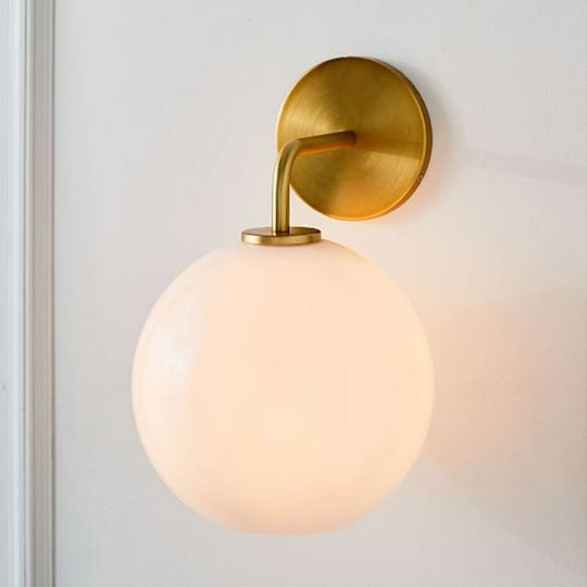 Modern Glass Orb Wall Sconce With Brass Arm Clear/White