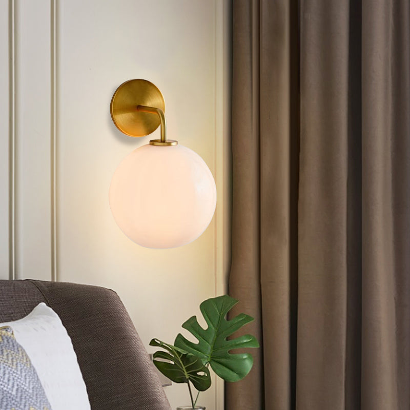 Modern Glass Orb Wall Sconce With Brass Arm Clear/White