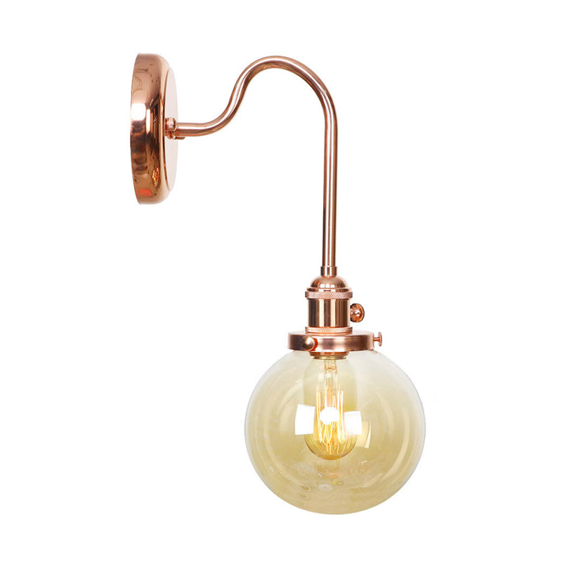 Copper Vintage Globe Wall Sconce With Curved Arm And Clear/Amber Glass - 1 Light