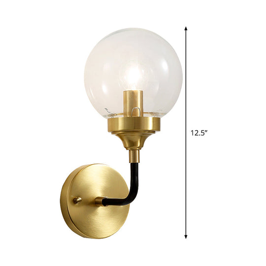 Clear Glass Globe Wall Sconce Light Fixture - Simple Brass With Curved Arm