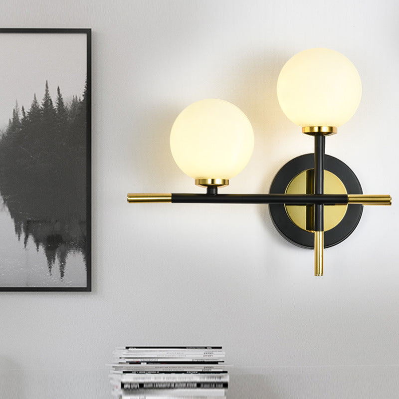 Modern Milk Glass Orb Sconce Wall Light - 2 Lights Black And Brass Cross Design