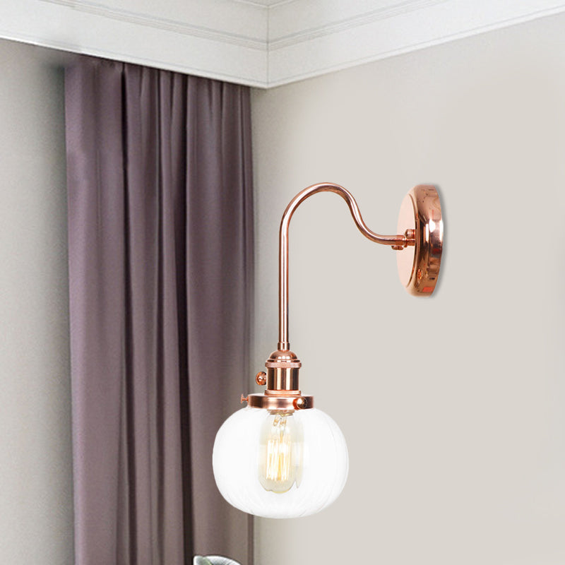 Copper Vintage Globe Wall Sconce With Curved Arm And Clear/Amber Glass - 1 Light