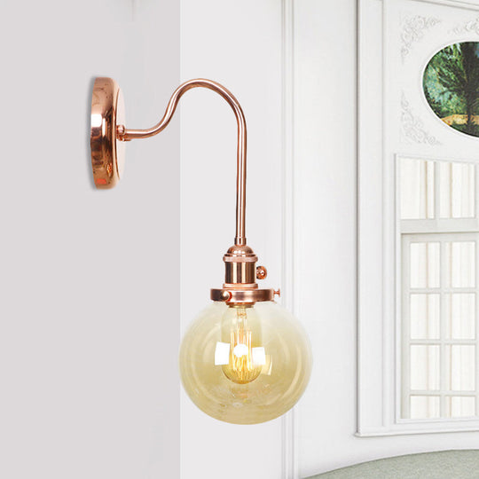 Copper Vintage Globe Wall Sconce With Curved Arm And Clear/Amber Glass - 1 Light