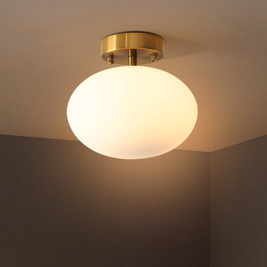 Sleek Gold Oval Semi Flush Light Fixture - Minimalist 1-Light Cream Glass Ceiling Lamp For Bedroom