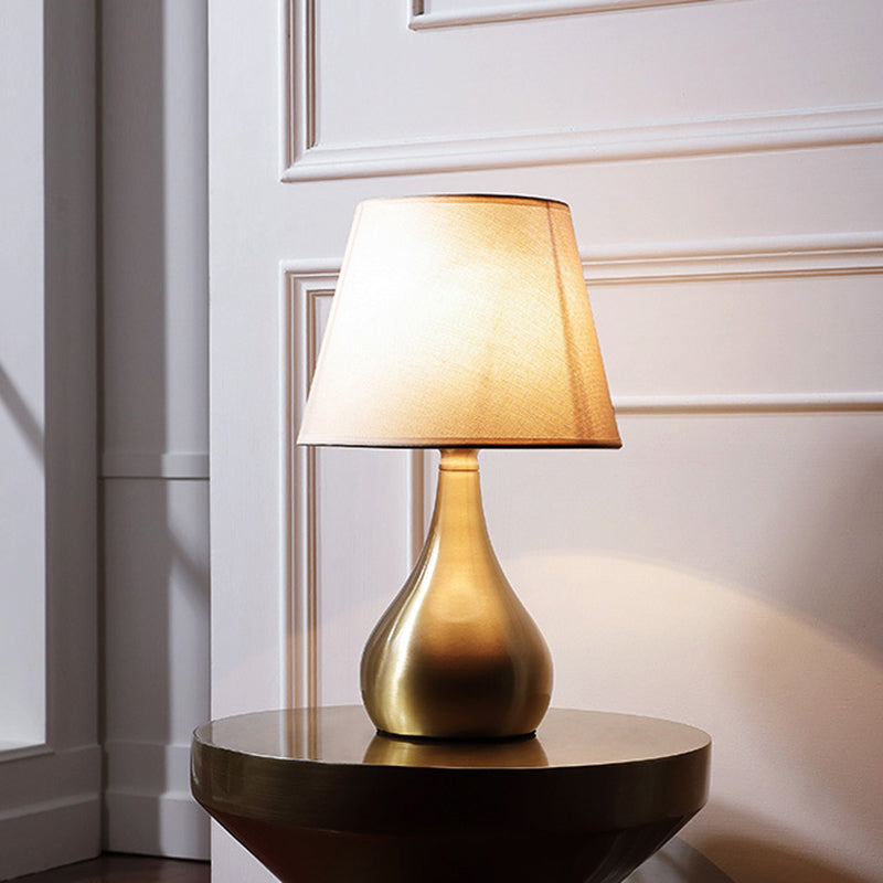 Sleek Metallic Urn-Shape Table Light - Simplicity 1-Light Brass Finish Lamp With Barrel Fabric Shade