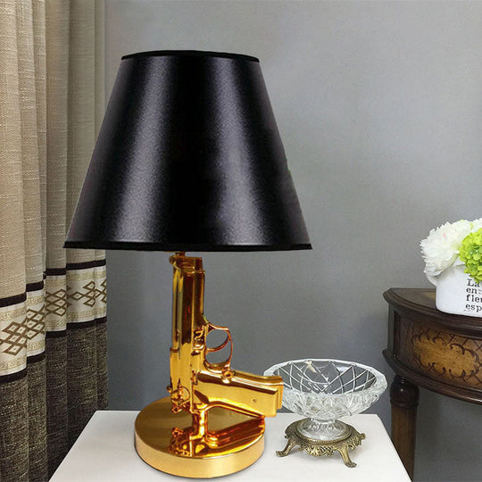 Modernist Black Barrel Shade Table Light With Gold Gun-Shaped Body - 1-Head Fabric Desk Lamp