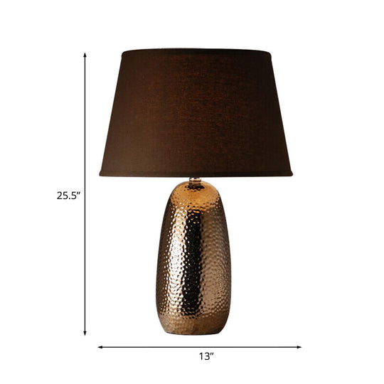 Rustic Hammered Ovoid Nightstand Lamp With Conical Fabric Shade In Brown For Bedroom