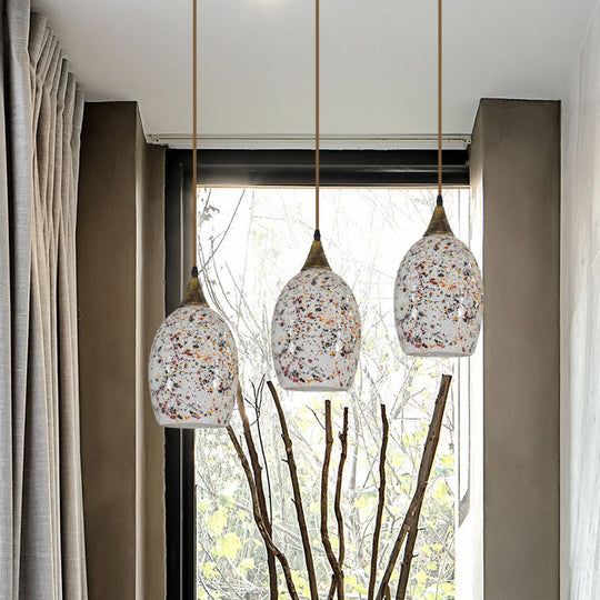 Spotted Glass Ellipse Multi-Pendant Light with Baroque Cut Brass and 3 Down Lights